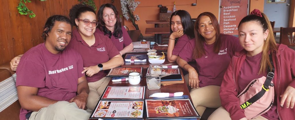 Dust Busters team in uniform celebrating a staff birthday – trusted, professional cleaning crew serving Union County NJ