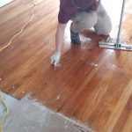 Dust Busters technician cleaning and polishing wood floors after construction in Union County NJ