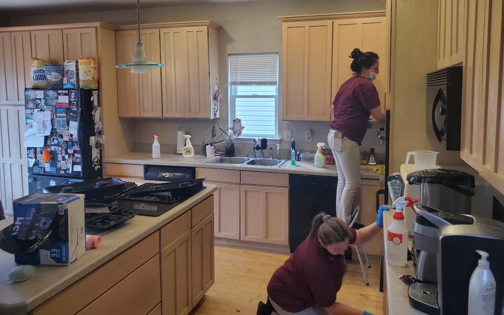 Residential cleaning service in Union County NJ – Dust Busters technician wiping kitchen counter