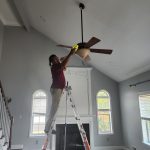 Dust Busters technician cleaning ceiling fan after construction – high-reach post-construction cleaning in Cranford NJ