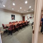 Cleaned office meeting room with organized chairs and conference table