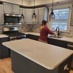 Dust Buster’s employee cleaning kitchen surfaces during residential service in Union County, NJ