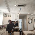 Dust Buster’s employee dusting a ceiling area during residential cleaning service in New Jersey