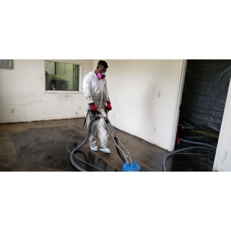 Warehouse concrete floor with oil stains before professional cleaning in New Jersey